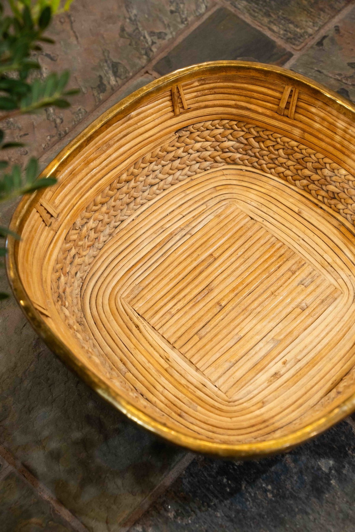 A brass mounted wicker basket