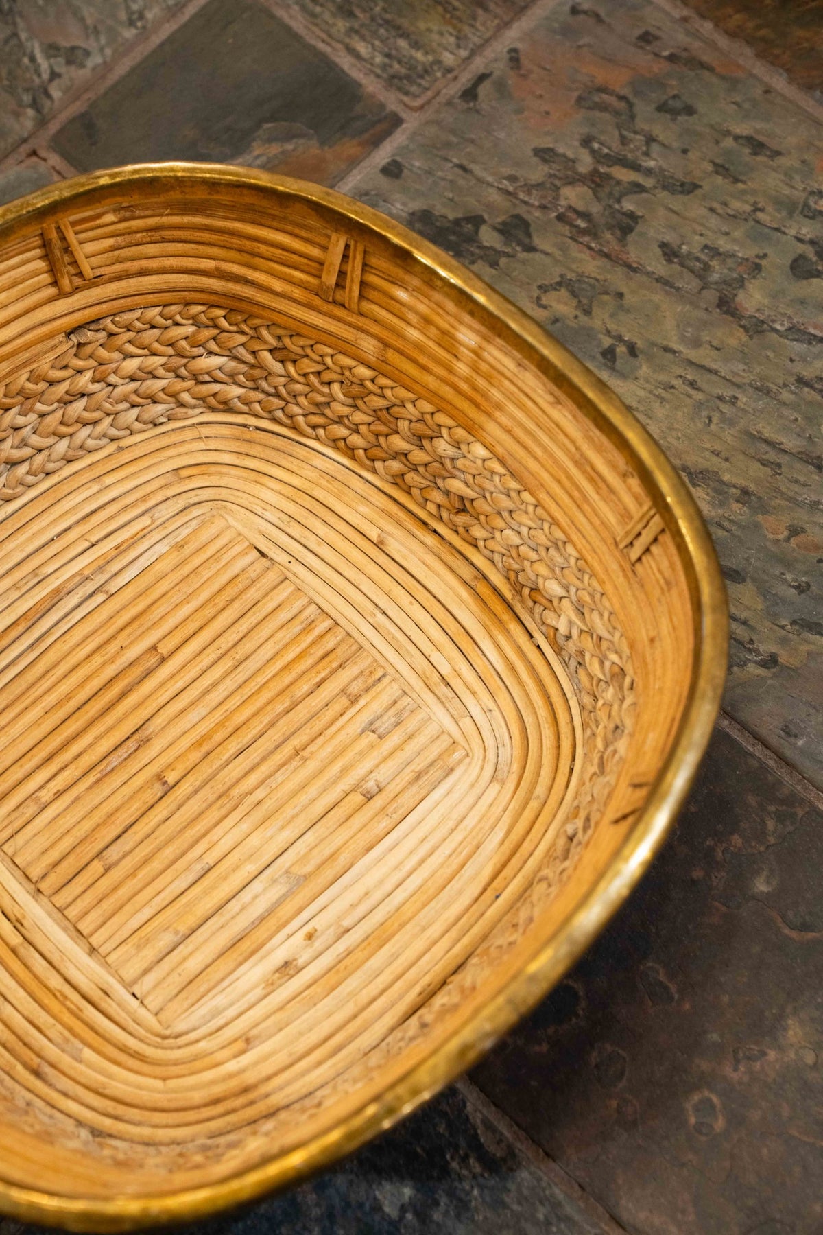 A brass mounted wicker basket