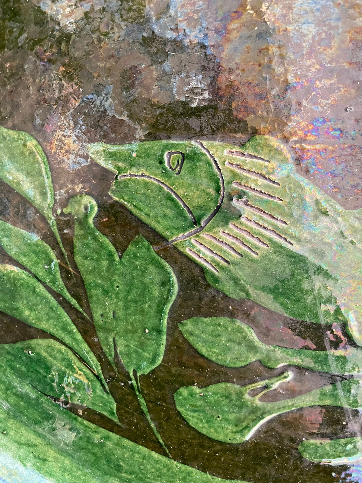 Large green glazed ceramic dish with a fish