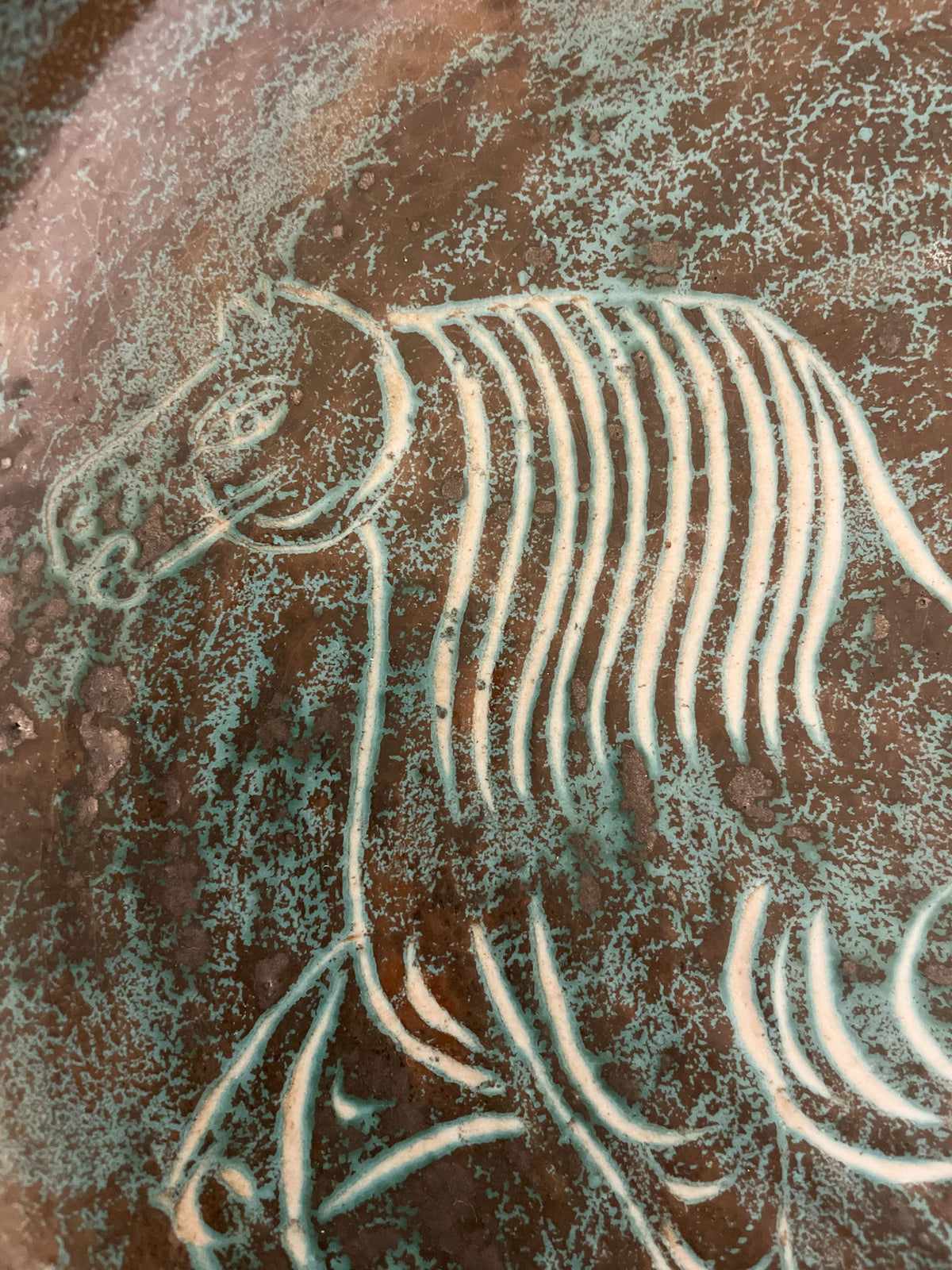 Large turquoise blue glazed ceramic bowl with a horse