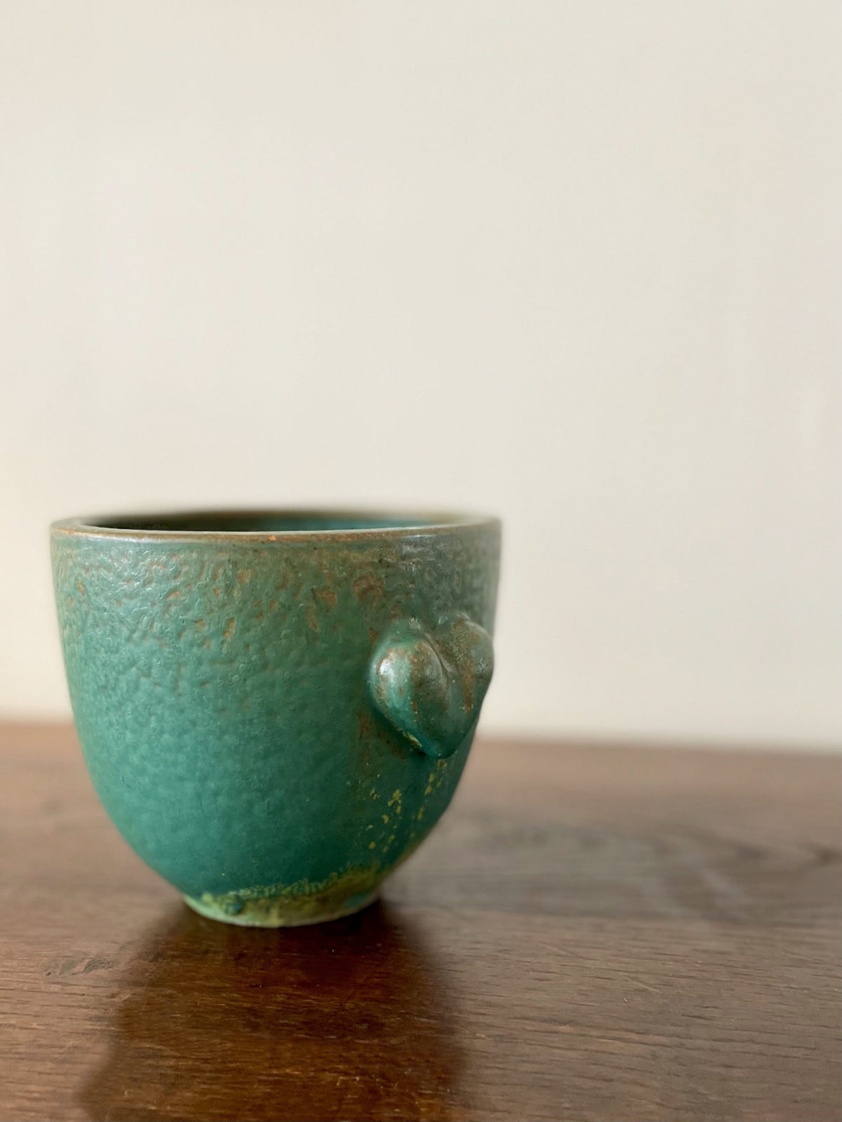 Green ceramic cup with two hearts