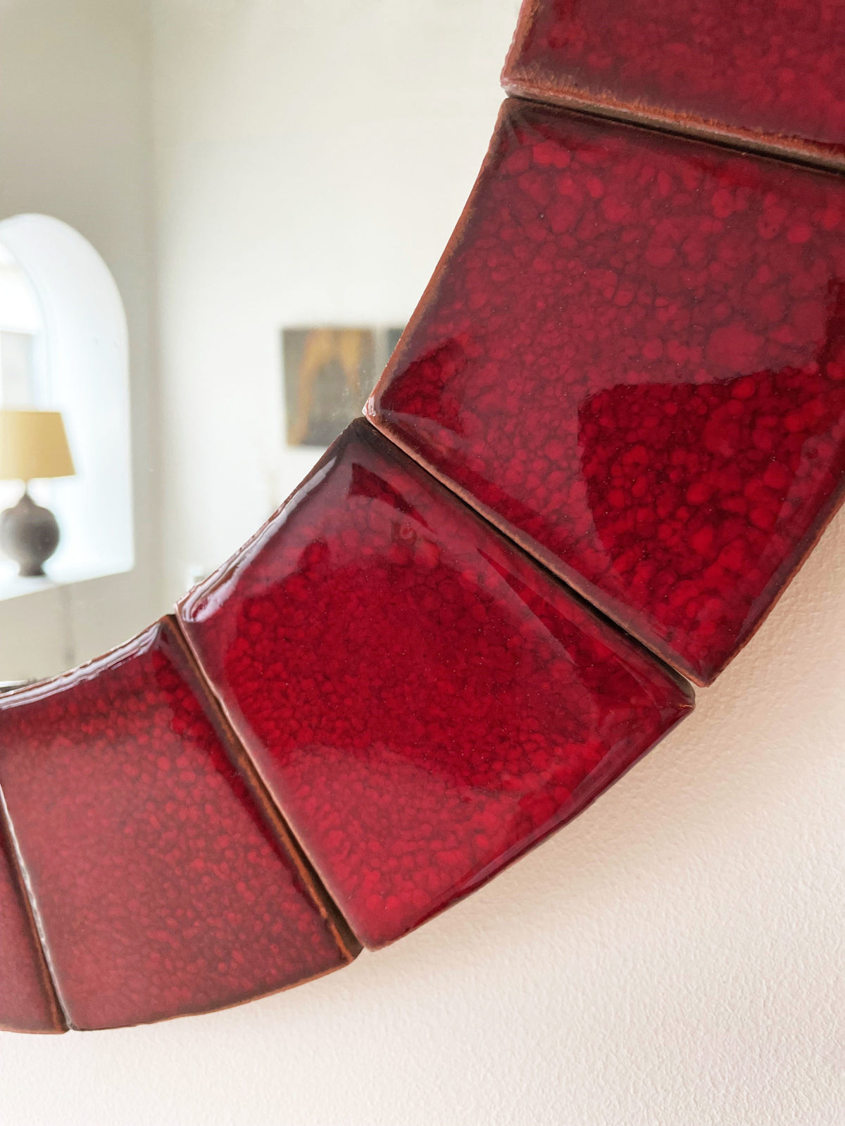 Circular red ceramic mirror