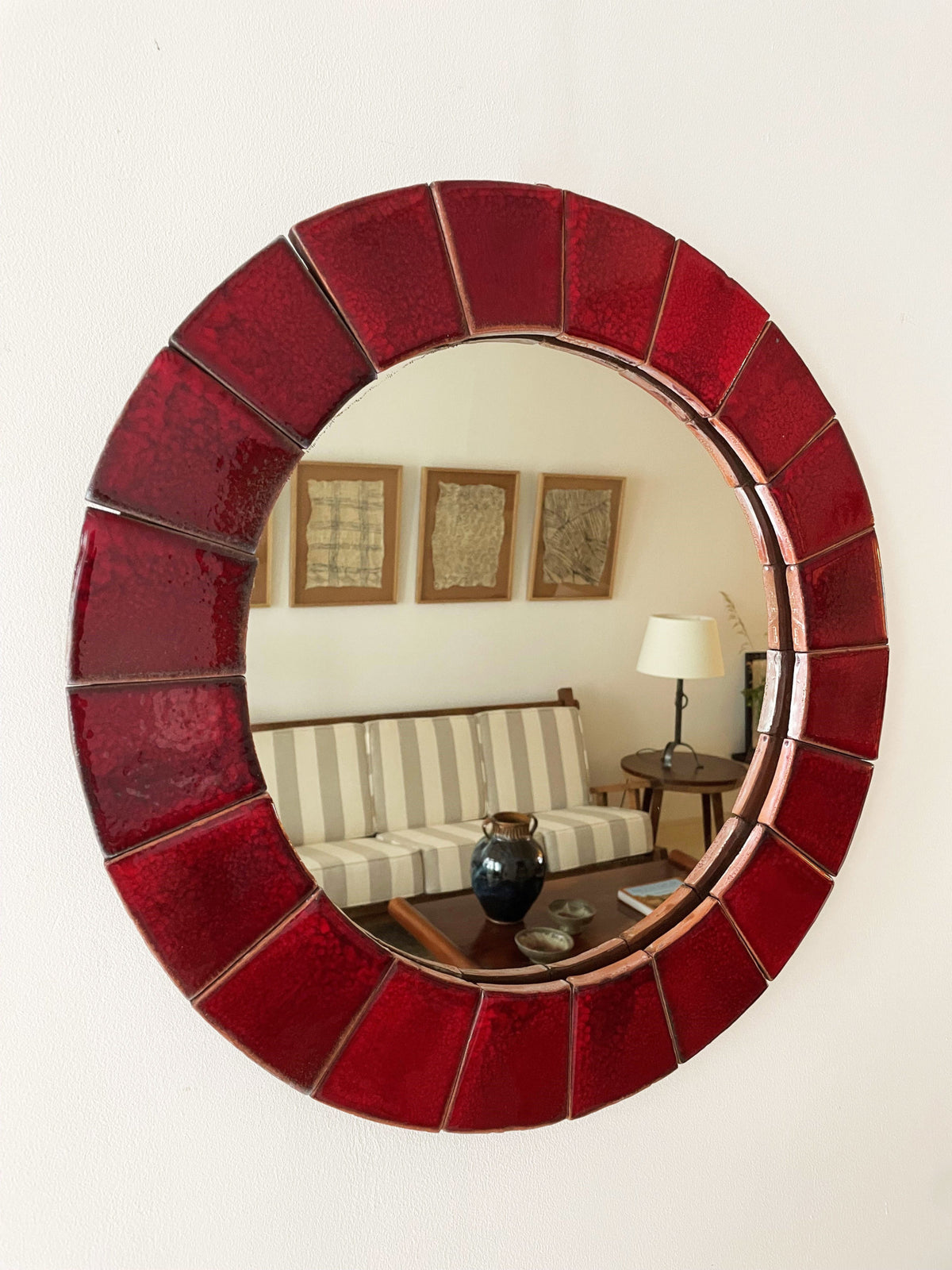 Circular red ceramic mirror
