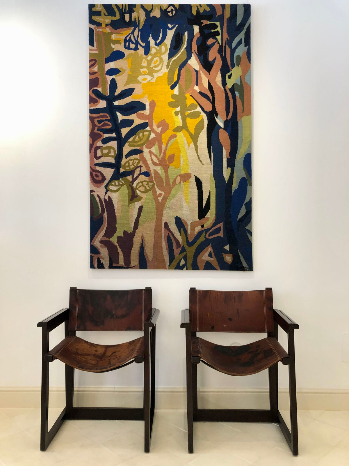 A pair of leather and beechwood chairs