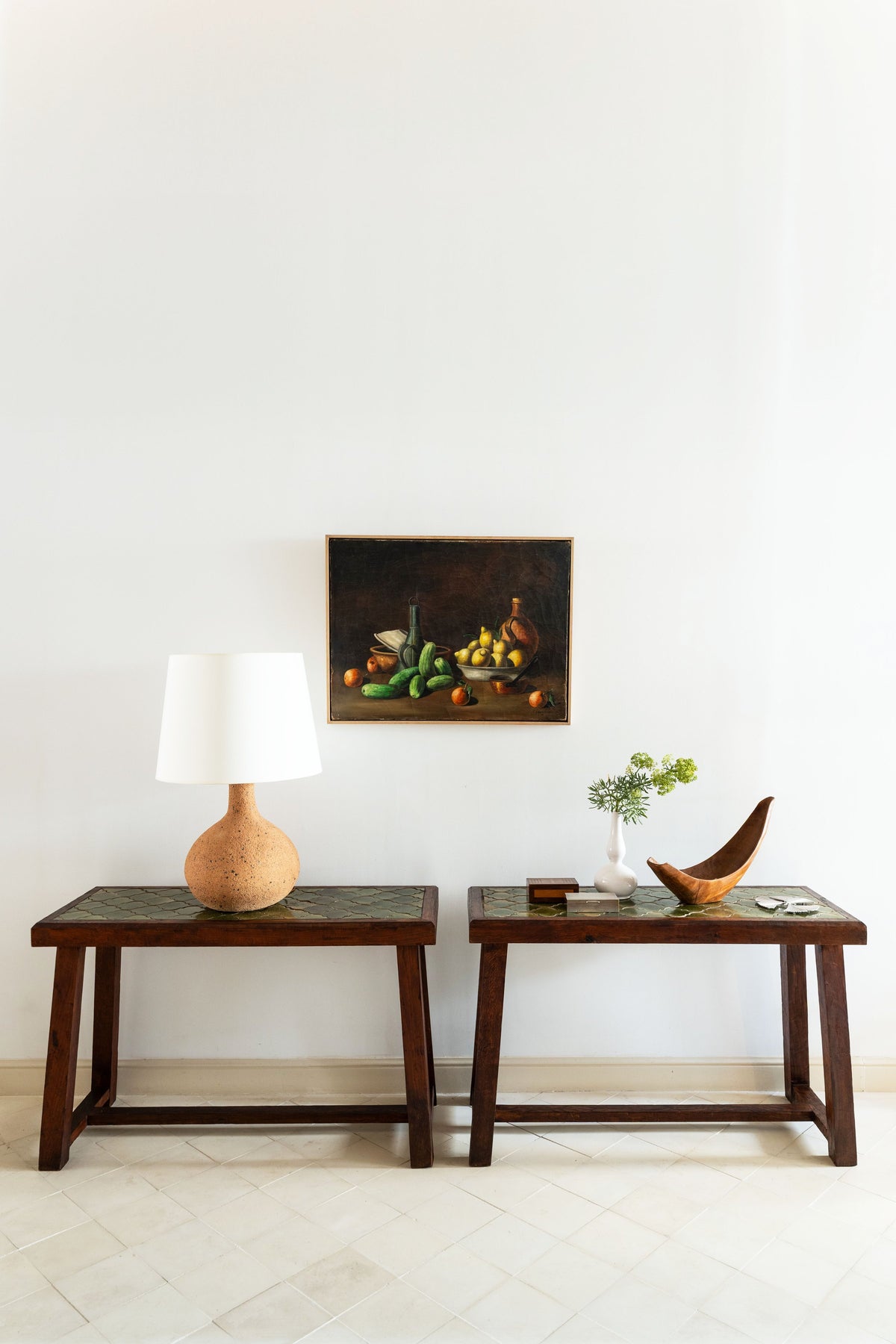 Pair of tiled-top console tables with a still life